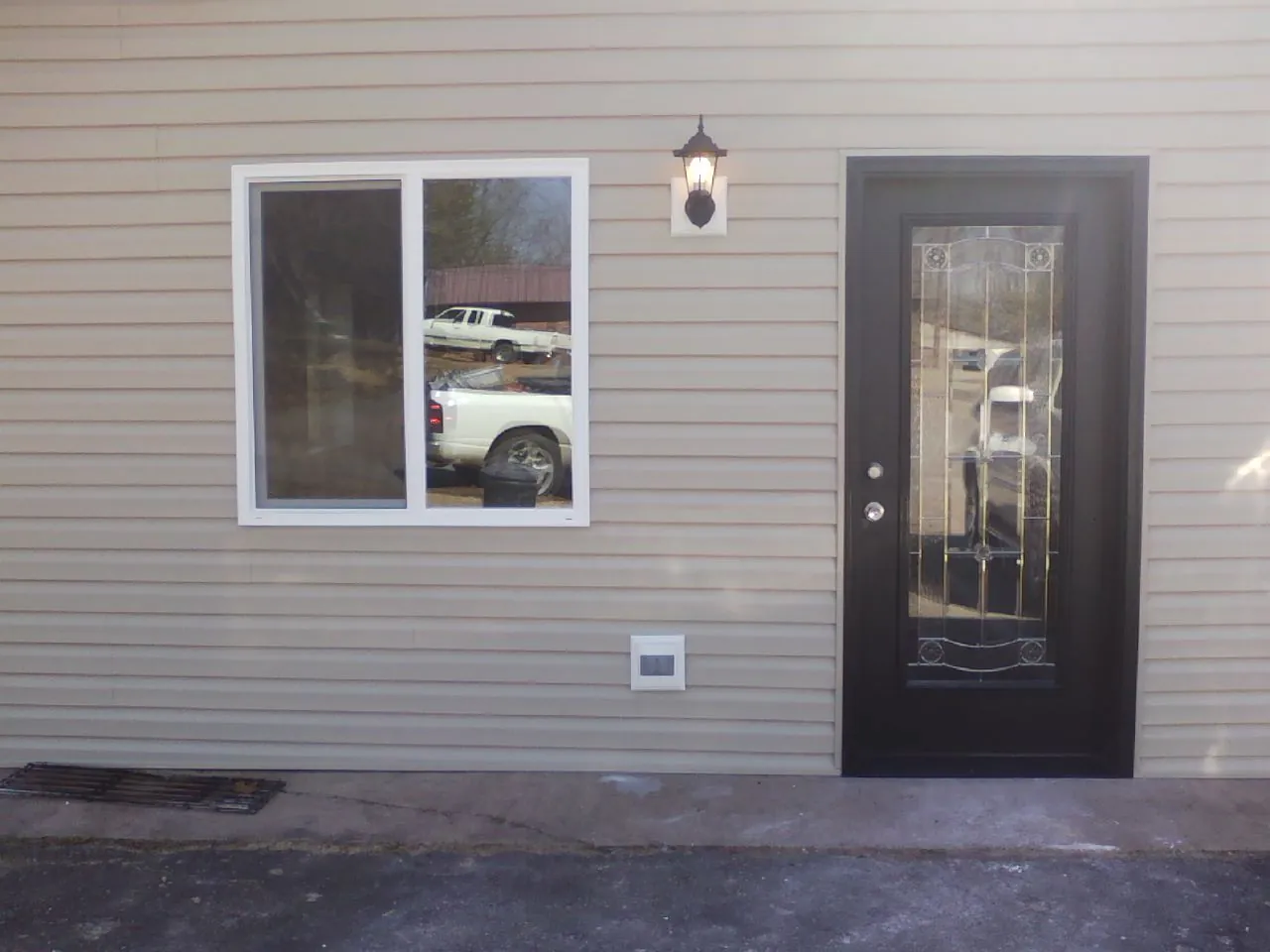 New siding, window and entry door on the side of an addition in Greenfield Center