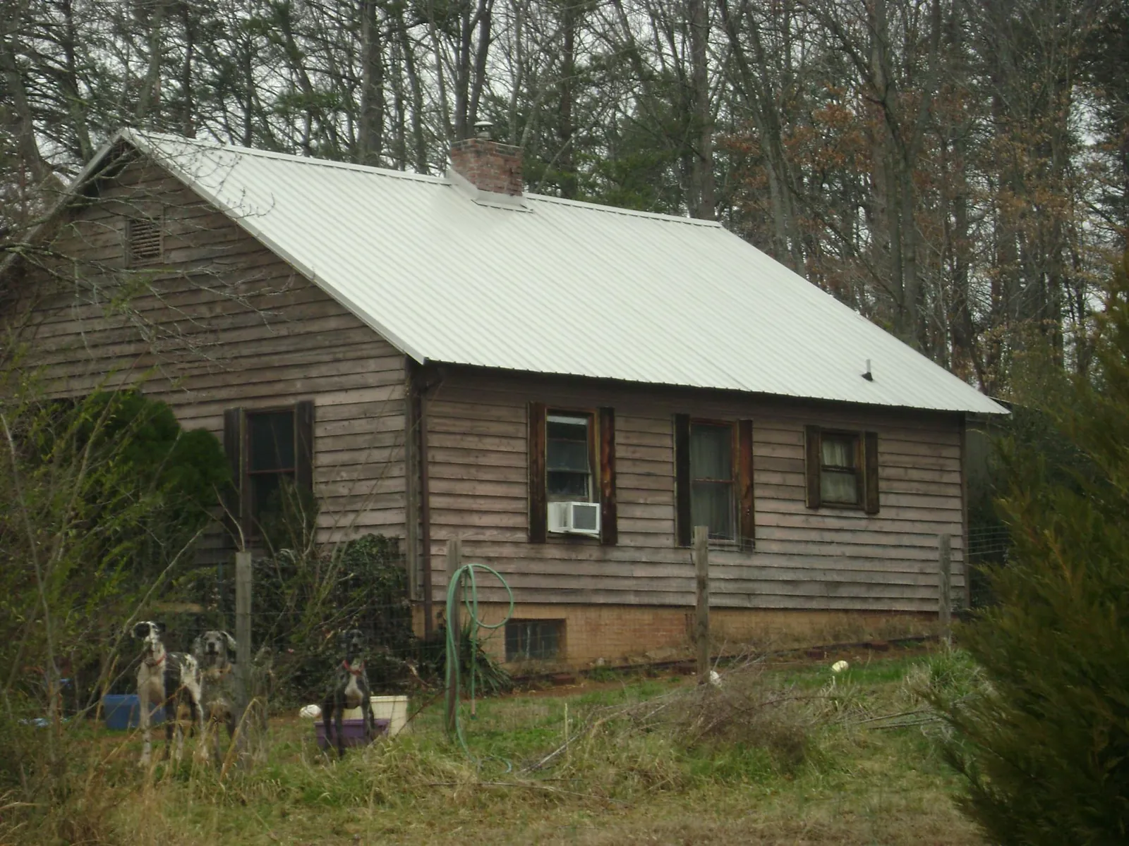 White metal roof on an old wood sided farmhouse, from a Metal Roof Installation job in Greenfield Center